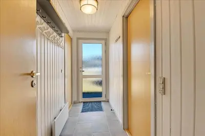 a hallway with a door and a window at 100-Harboore-Vejlby-Klit-51 in Harboør