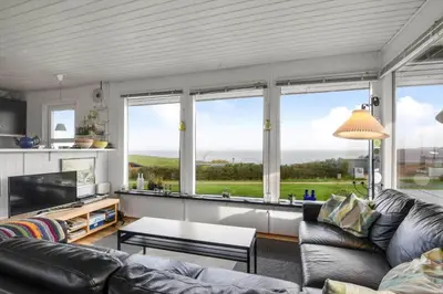 a living room with a couch and a large window at G230-Lemvig-Gyvelvej-30 in Lemvig