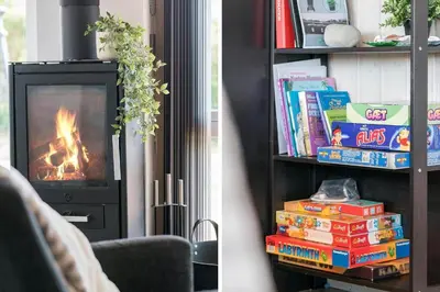 a living room with a book shelf with books and a fireplace at 212-Harboore-Neerlandiavej-62 in Harboør