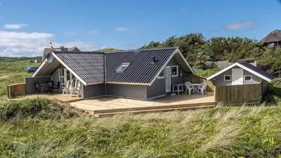 a house on a wooden deck in the middle of a field at 108-Harboore-Merchantvej-10-C in Harboør