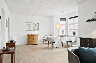a living room with a dining room table with chairs at 713-Thyboron-Vesterhavsgade-34 in Thyborøn