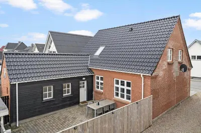 a house with a bench in front of it at 713-Thyboron-Vesterhavsgade-34 in Thyborøn