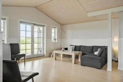 a living room with a couch and a table at 187-Harboore-Neerlandiavej-1 in Harboør