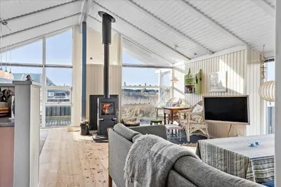 a living room with a couch and a fireplace at 248-Harboore-Viktoriavej-16 in Harboør