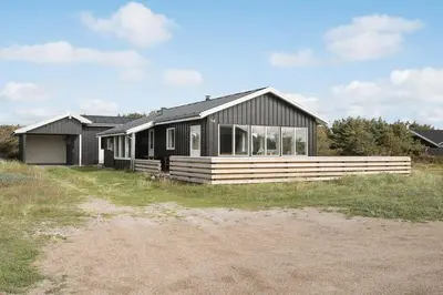 a black house with a lot of windows at 355-Harboore-Gloryvej-14 in Harboør