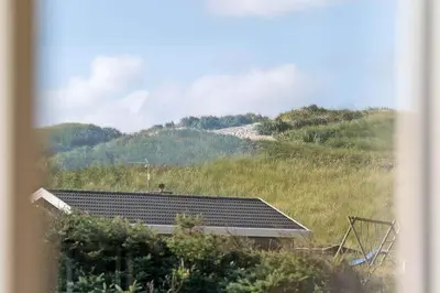 a house with a solar panel on top of a hill at 355-Harboore-Gloryvej-14 in Harboør