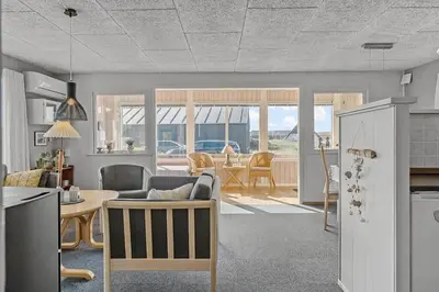 a kitchen and living room with a table and chairs at 355-Harboore-Gloryvej-14 in Harboør