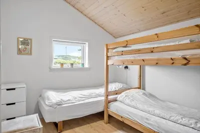 a bedroom with two bunk beds and a window at G124-Lemvig-Porsevej-24 in Lemvig