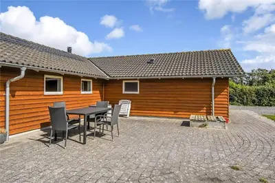 a patio with a table and chairs in front of a building at G124-Lemvig-Porsevej-24 in Lemvig