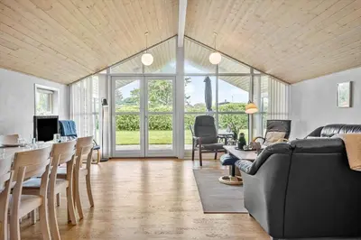 a living room with a couch and a table and chairs at G124-Lemvig-Porsevej-24 in Lemvig