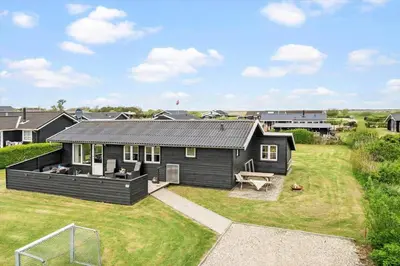 a black house with a large yard in front of it at G305-Lemvig-Porsevej-105 in Lemvig