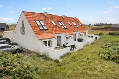 a house with an orange roof on a hill at 323-Harboore-Skalvej-4-a in Harboør