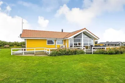a yellow house with a large green yard at G131-Lemvig-Skovstjernevej-31 in Lemvig