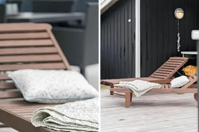 a wooden chair sitting on a porch with a blanket at 119-Harboore-Neerlandiavej-32 in Harboør