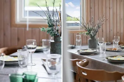 a table with glasses and plates of food and a window at 119-Harboore-Neerlandiavej-32 in Harboør