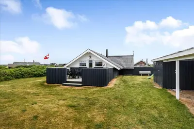 a house with a fence and a yard at 209-Harboore-Vejlby-Klit-291-A in Harboør