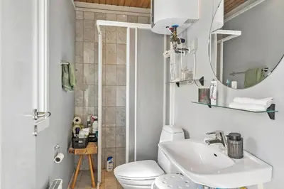 a bathroom with a white toilet and a sink at G120-Lemvig-Gyvelvej-20 in Lemvig