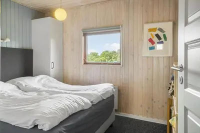 a bedroom with a bed and a window at 134-Harboore-Karolinevej-8 in Harboør