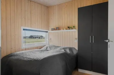 a bedroom with a bed and a window at 227-Harboore-Bjergehusvej-4 in Harboør