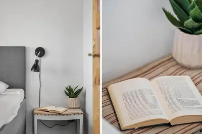 a book on a table next to a lamp and a plant at G147-Lemvig-Syrenvej-47 in Lemvig