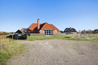 a house with a playground in front of it at 377-Harboore-Fourmivej-56 in Harboør
