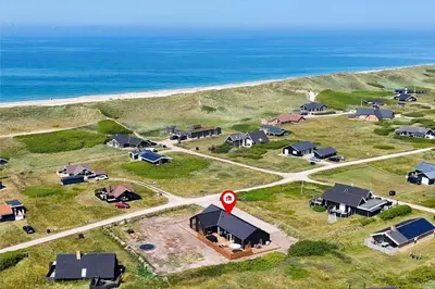 an aerial view of a group of houses near the ocean at 802-Harboore-Lucievej-13 in Harboør
