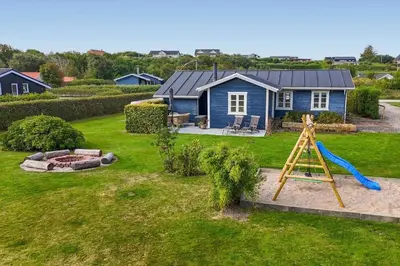 a blue house with a slide and a playground at G410-Lemvig-Porsevej-10 in Lemvig