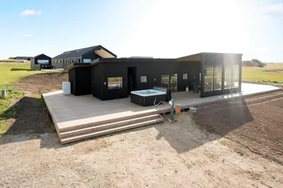 a large black house with a deck at G422-Lemvig-Pragtstjernevej-22 in Lemvig