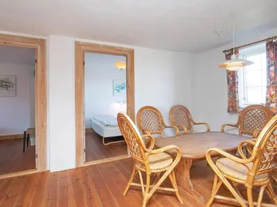 a dining room with a wooden table and chairs at 12 person holiday home in Lemvig in Lemvig