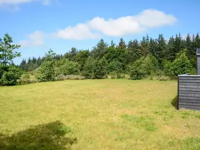 a large open field with trees in the background at Tranquil Retreat in Nature s Embrace-By Traum in Brovst