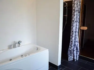 a white bath tub in a bathroom with a shower at Tranquil Retreat in Nature s Embrace-By Traum in Brovst