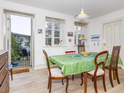 a kitchen and dining room with a table and chairs at 5 person holiday home in Løgstør in Løgstør