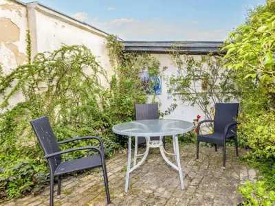 three chairs and a table and a table and chairs at 5 person holiday home in Løgstør in Løgstør
