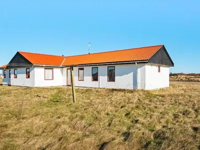 a white house with an orange roof on a field at 10 person holiday home in Harboøre-By Traum in Harboør