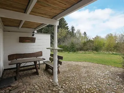 a picnic table and a bench under a pavilion at 10 person holiday home in Fur in Fur