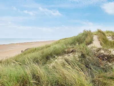 a sand hill with a beach in the background at Seaside Serenity in TAYsinge-By Traum in Brovst