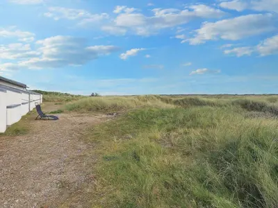 a bench sitting in the middle of a field at Seaside Serenity in TAYsinge-By Traum in Brovst