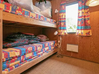 a bedroom with two bunk beds and a window at 6 person holiday home in Vinderup in Vinderup