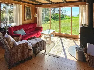 a living room with a red couch and a table at 6 person holiday home in Vinderup in Vinderup