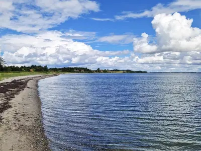a view of a body of water with a beach at 6 person holiday home in Thyholm in Thyholm