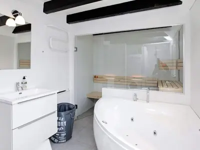 a white bathroom with a tub and a sink at 7 person holiday home in Fjerritslev-By Traum in Fjerritslev
