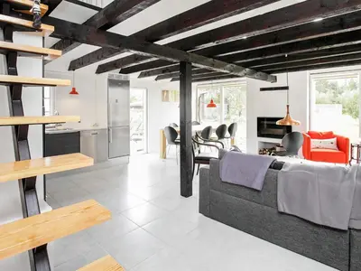 a living room with a couch and a kitchen at 7 person holiday home in Fjerritslev-By Traum in Fjerritslev