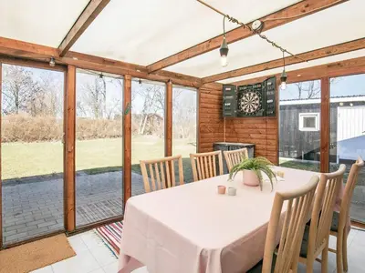 a dining room with a white table and chairs at 8 person holiday home in Vinderup-By Traum in Vinderup