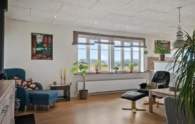 a living room with chairs and tables and windows at Stunning Home In Harboøre With Wifi in Harboør
