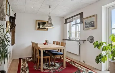 a dining room with a table and a refrigerator at Stunning Home In Harboøre With Wifi in Harboør