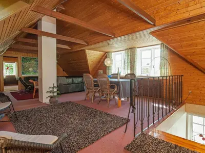 a living room with a table and chairs at Luxury Retreat with Pool - By Traum Ferienwohnungen in Thyholm