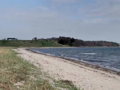 a dirt road next to a body of water at Luxury Retreat with Pool - By Traum Ferienwohnungen in Thyholm