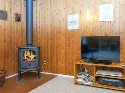 a living room with a stove and a television at 6 person holiday home in Struer-By Traum in Struer