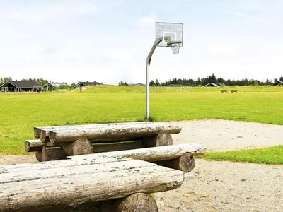 a bench and a basketball hoop with a basket at Holiday home for 24 guests, Brovst in Brovst