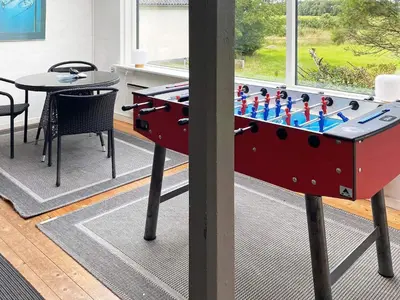 a large ping pong table in a living room with a table and a table at Scenic Retreat in Boddum - By Traum Ferienwohnungen in Boddum